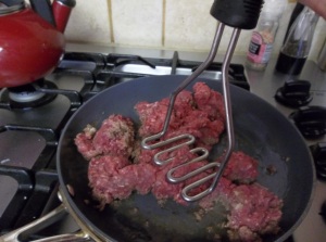 I find that a potato masher works well to initially break up the ground beef.